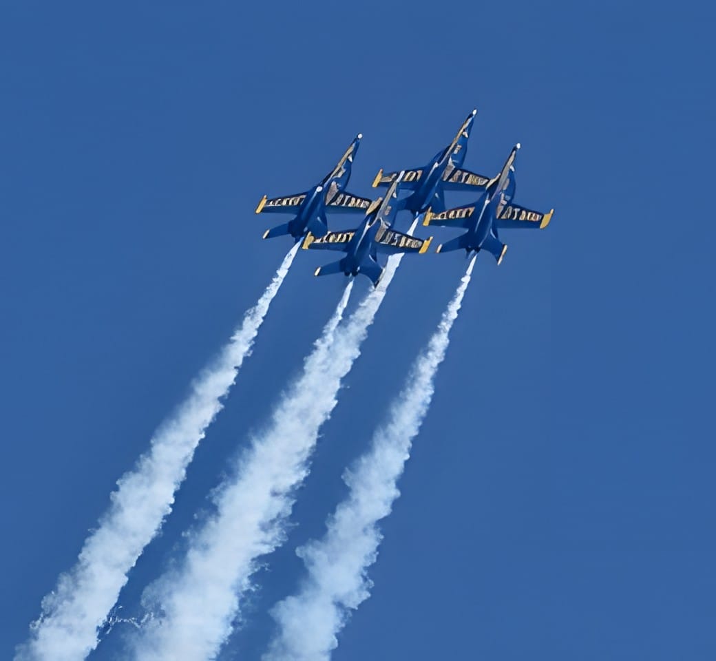 Four Blue Angels jets in diamond formation