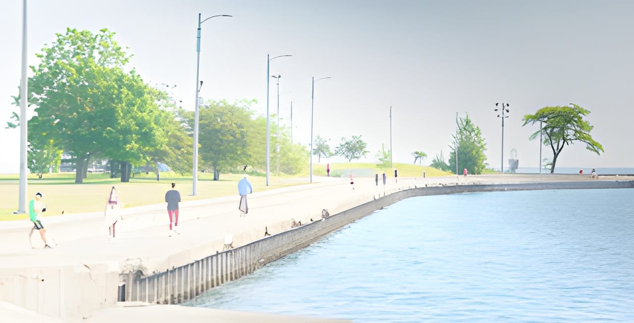 People walking the lakefront promenade on a soft summer day