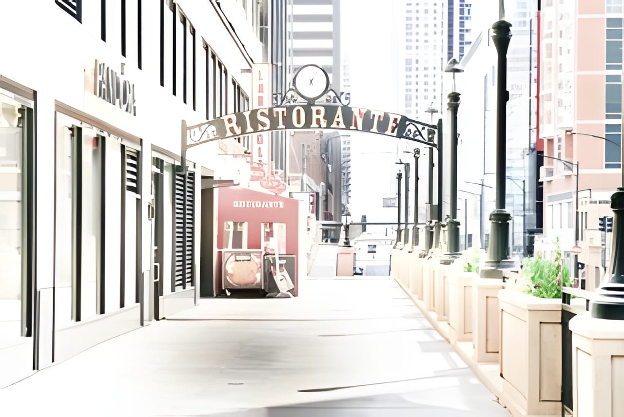An empty city side street under a Ristorante arch in soft warm pastel