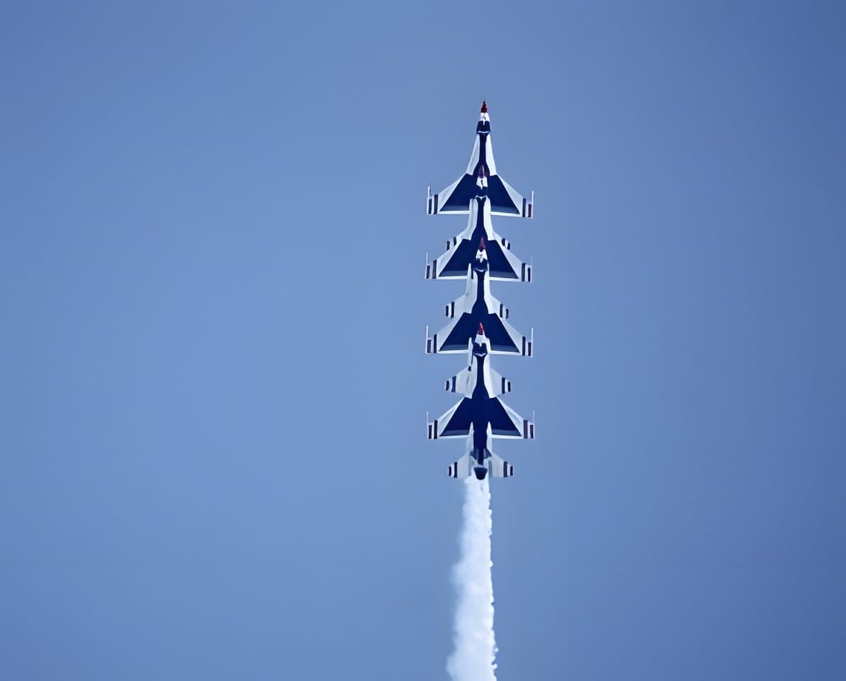 Four Thunderbirds jets climbing vertically in formation