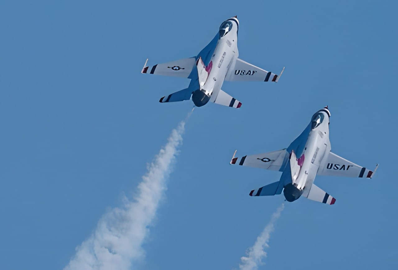 Two Thunderbirds jets trailing white smoke
