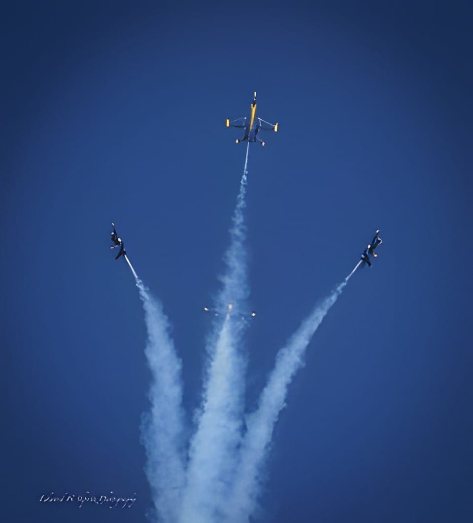 Several jets bursting outward in different directions, trailing smoke