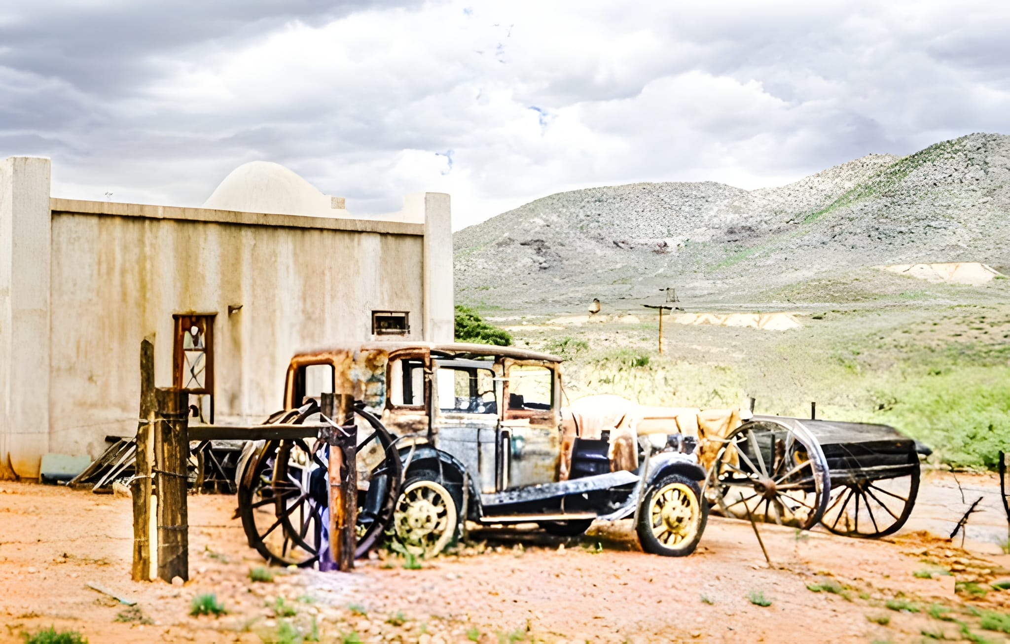 A rusted automobile at rest outside town — by Ed Shpritz