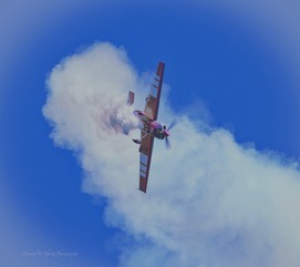 A single aerobatic plane in a cloud of its own smoke