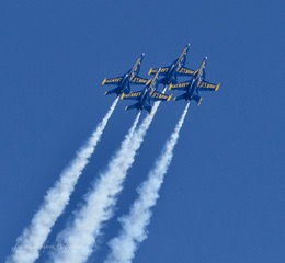 Four Blue Angels jets in diamond formation