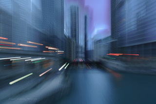 City skyscrapers and light trails blurred by intentional camera movement