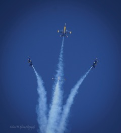 Several jets bursting outward in different directions, trailing smoke
